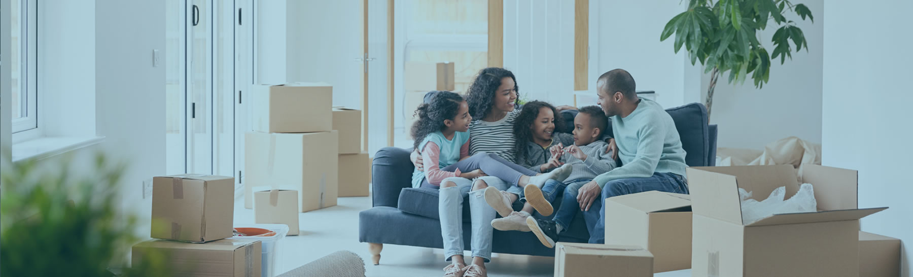 Family Relaxing After Moving Into New Home