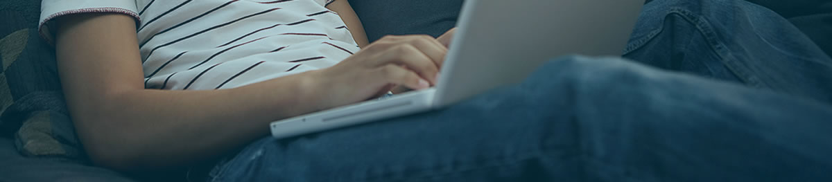 Man on couch using computer